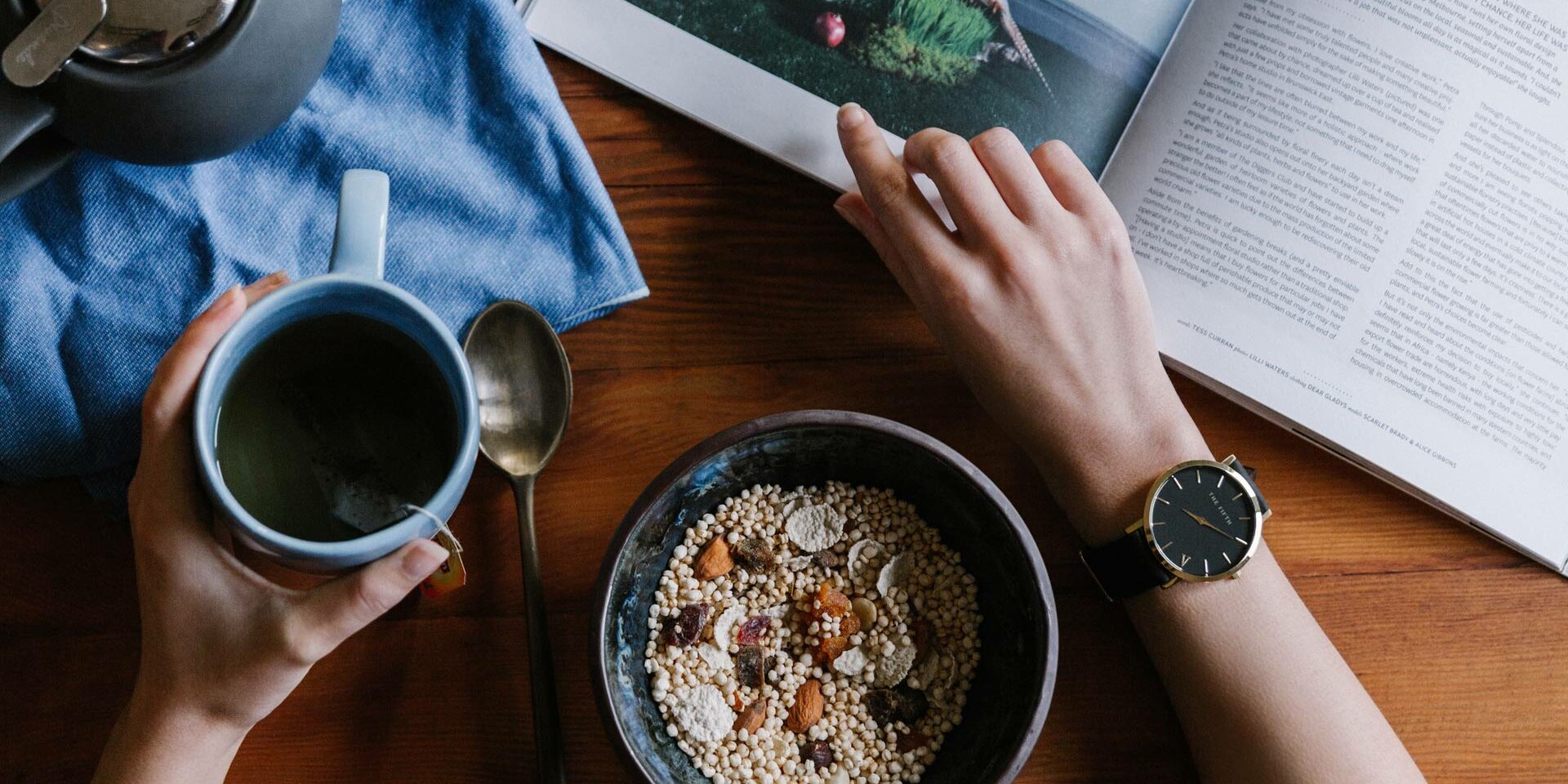 Image of a person eating breakfast whilst reading