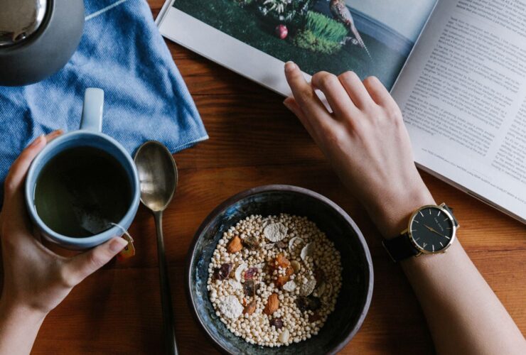 Image of a person eating breakfast whilst reading