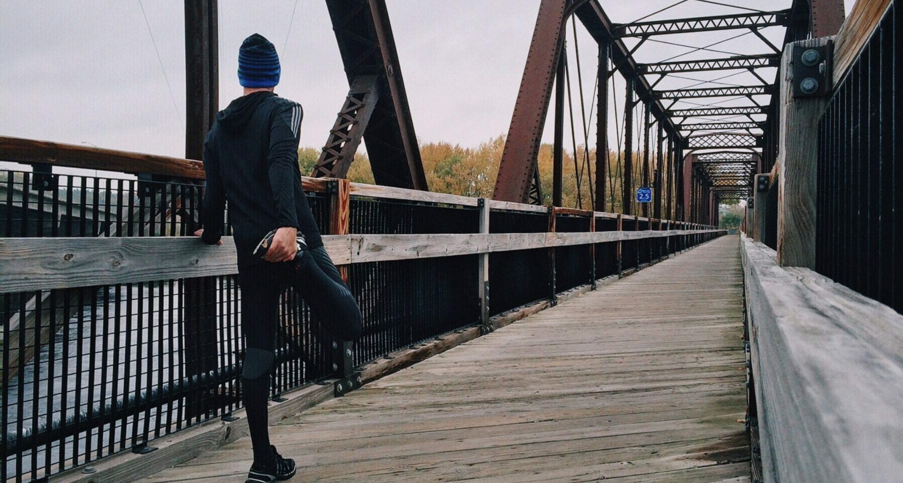 Image of a man running outdoors on a bridge